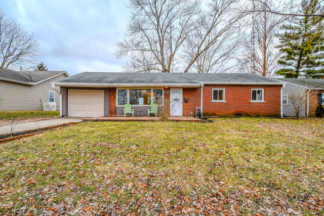 ranch-style house featuring a garage and a front lawn