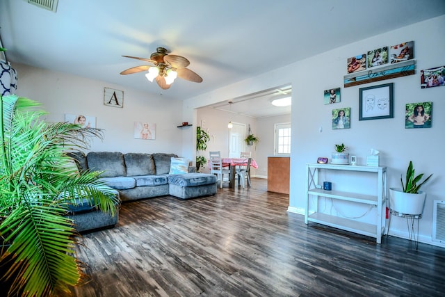 living room featuring ceiling fan and dark hardwood / wood-style floors