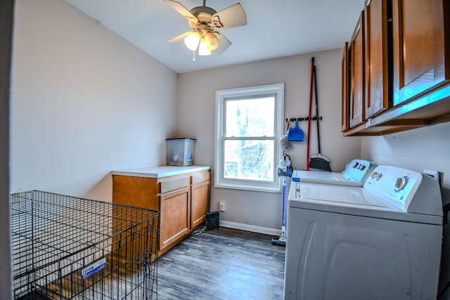 laundry area featuring dark wood-type flooring, washer and clothes dryer, cabinets, and ceiling fan