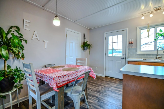 dining area with dark hardwood / wood-style floors and sink