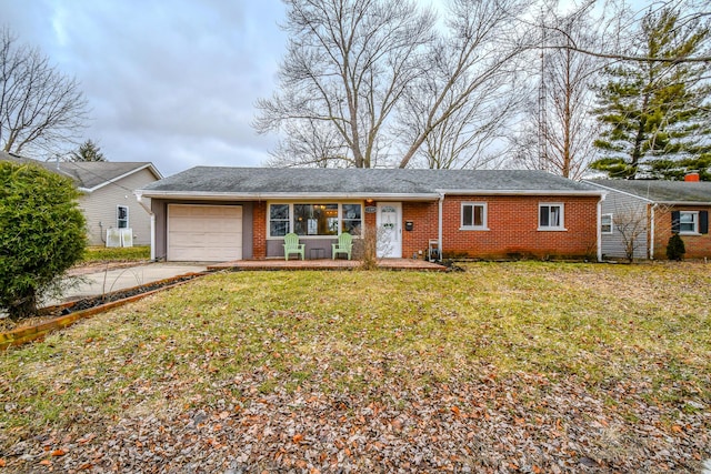 ranch-style house featuring a garage and a front lawn