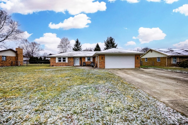 single story home featuring brick siding, concrete driveway, fence, a garage, and a front lawn