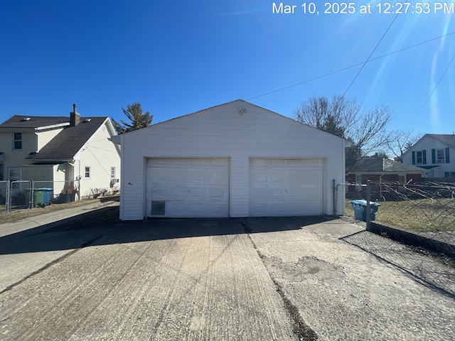 detached garage featuring fence