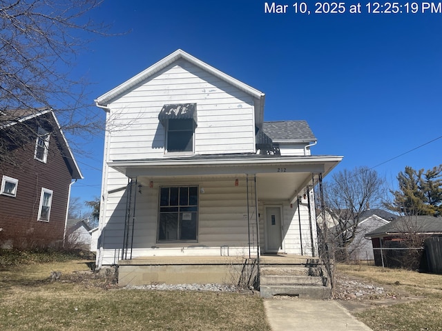 view of front of home with fence, covered porch, and roof with shingles