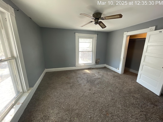 unfurnished bedroom with a closet, ceiling fan, carpet, and baseboards