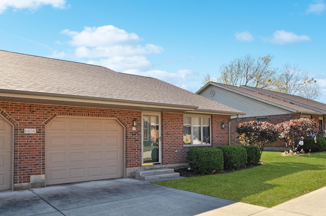 single story home with an attached garage, a front yard, driveway, and brick siding