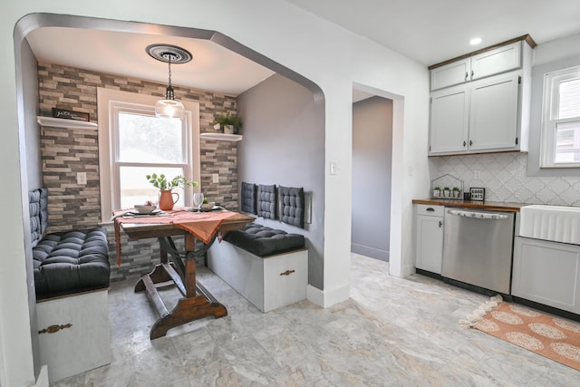 interior space featuring baseboards and arched walkways