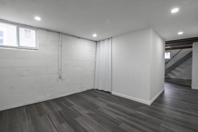 basement with dark wood-type flooring, recessed lighting, baseboards, and stairs