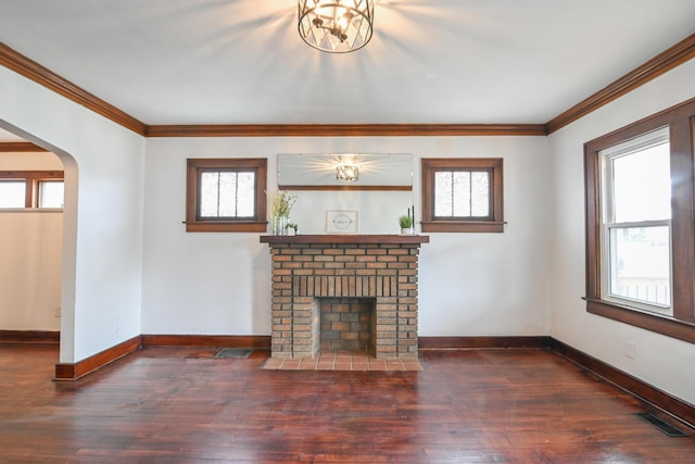 unfurnished living room with arched walkways, a fireplace, visible vents, dark wood-type flooring, and baseboards