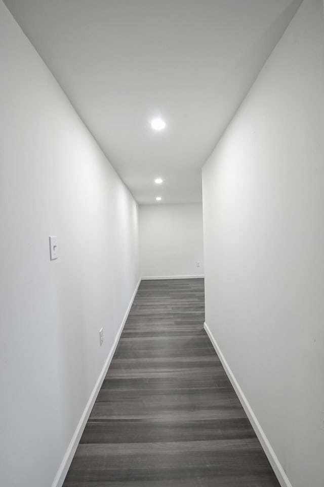 hallway with dark wood-style flooring, recessed lighting, and baseboards