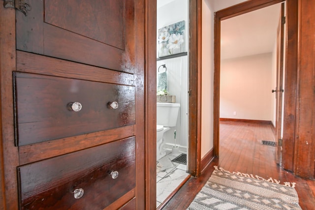 interior details featuring baseboards, visible vents, and wood finished floors