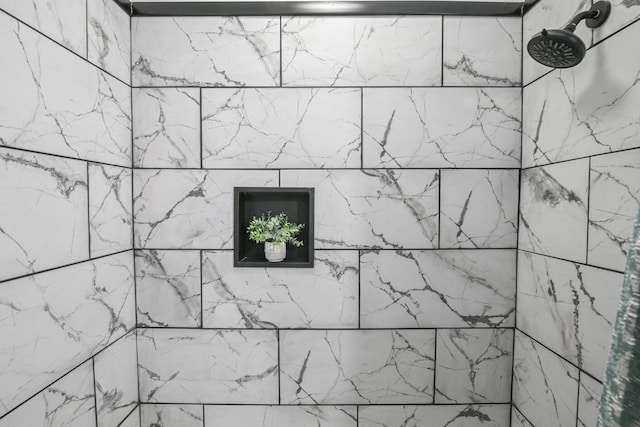 interior details with a tile shower