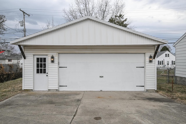 detached garage featuring fence