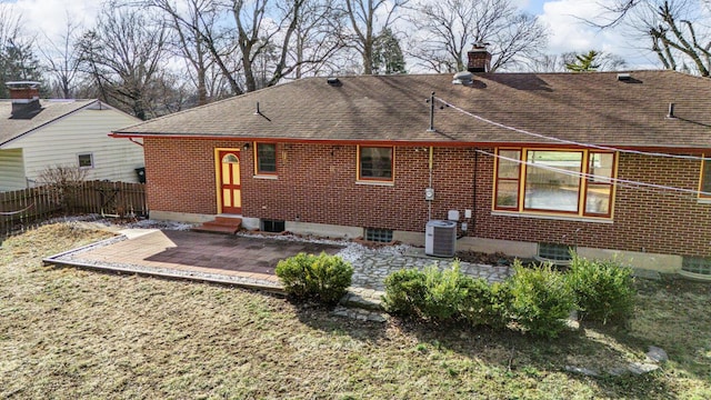 rear view of property with central AC unit and a patio