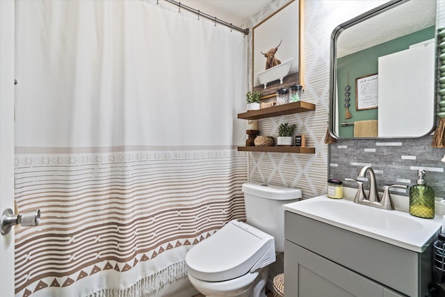 full bath with toilet, tasteful backsplash, and vanity