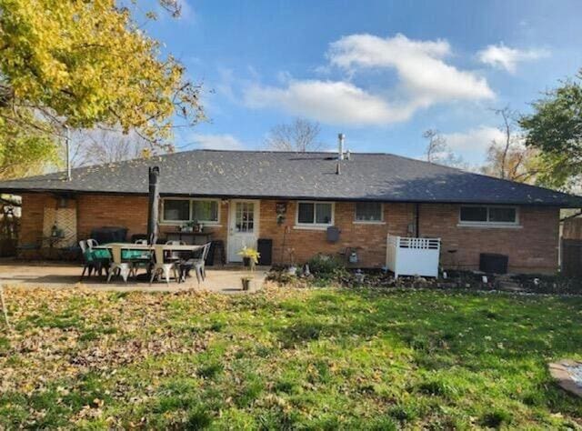 back of house featuring a patio and a lawn