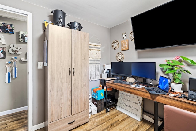 office area with baseboards and wood finished floors