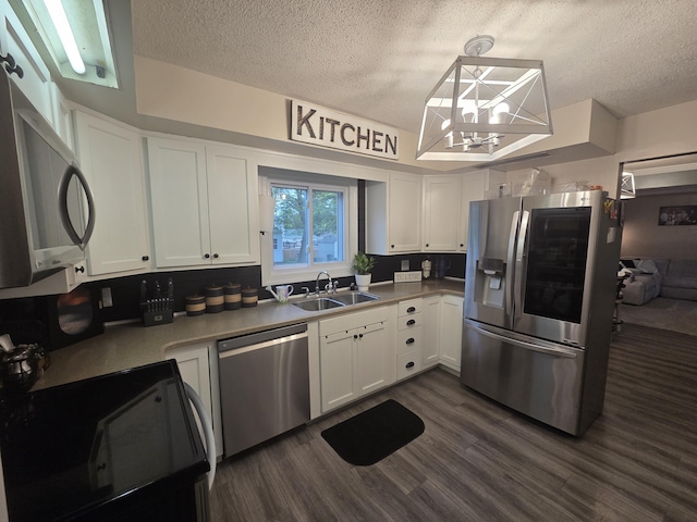 314 Concord Ave, Saint Marys, OH 45885 - kitchen with stainless steel appliances, a sink, a textured ceiling, white cabinets, and dark wood-type flooring