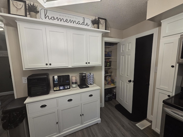 314 Concord Ave, Saint Marys, OH 45885 - kitchen featuring dark wood finished floors, light countertops, white cabinets, stainless steel range with electric stovetop, and a textured ceiling