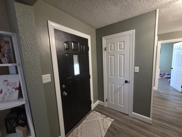 314 Concord Ave, Saint Marys, OH 45885 - entryway with wood finished floors, baseboards, and a textured ceiling