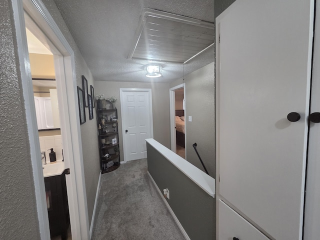 314 Concord Ave, Saint Marys, OH 45885 - corridor featuring dark colored carpet, an upstairs landing, attic access, and baseboards