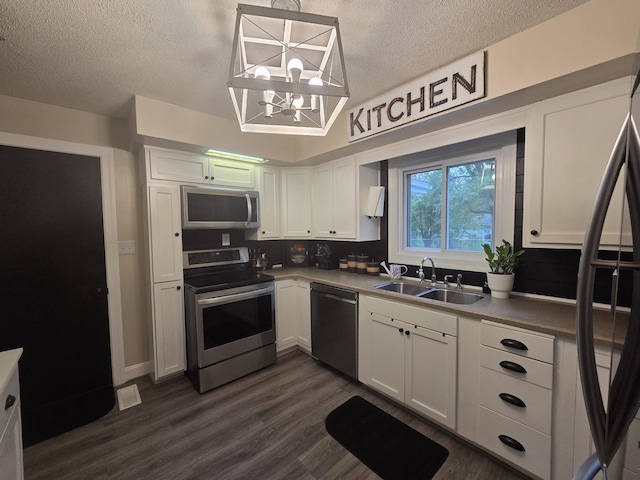 314 Concord Ave, Saint Marys, OH 45885 - kitchen with appliances with stainless steel finishes, a sink, a textured ceiling, a chandelier, and white cabinets