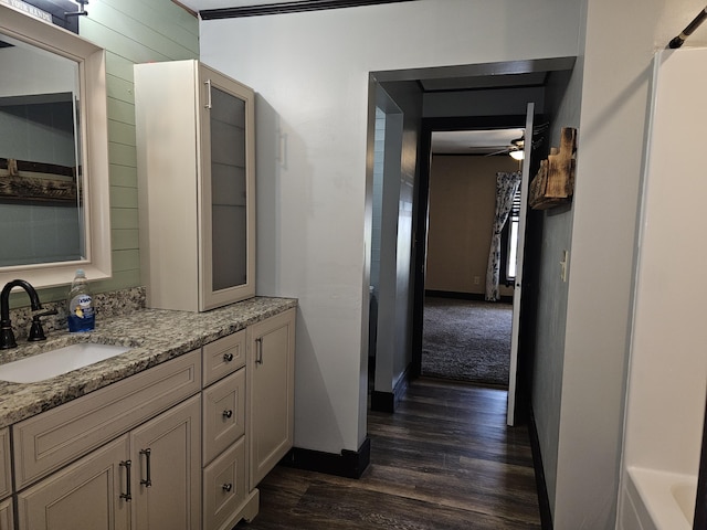 2 E Main St, Fletcher, OH 45326 - bathroom with wood finished floors, vanity, ceiling fan, and a bath