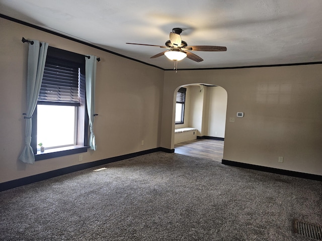 2 E Main St, Fletcher, OH 45326 - carpeted spare room with arched walkways, ceiling fan, and crown molding