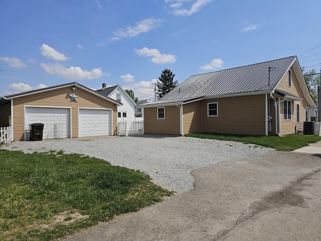 2 E Main St, Fletcher, OH 45326 - view of home's exterior with an outdoor structure, a metal roof, a garage, and gravel driveway
