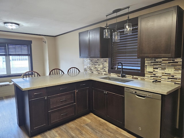 2 E Main St, Fletcher, OH 45326 - kitchen featuring stainless steel dishwasher, a peninsula, tasteful backsplash, ornamental molding, and light wood finished floors