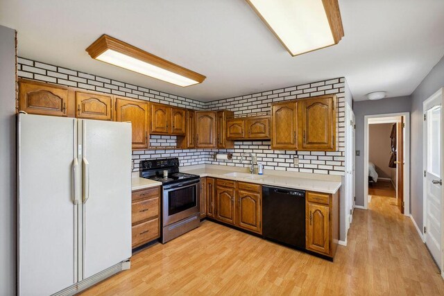 1405 Providence Ave, Springfield, OH 45503 - kitchen featuring freestanding refrigerator, dishwasher, electric stove, and brown cabinetry