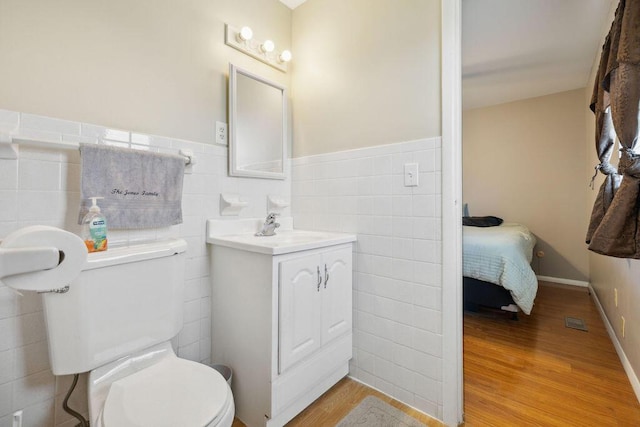 1405 Providence Ave, Springfield, OH 45503 - half bathroom with tile walls, vanity, wood finished floors, and wainscoting