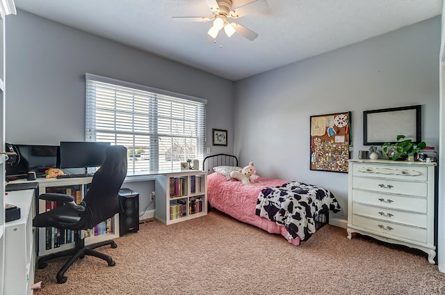 carpeted bedroom with baseboards and ceiling fan