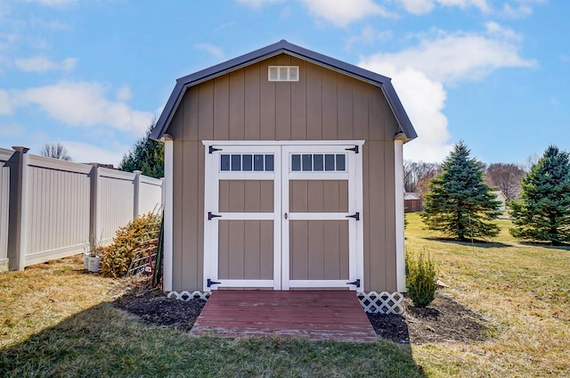 view of shed featuring fence