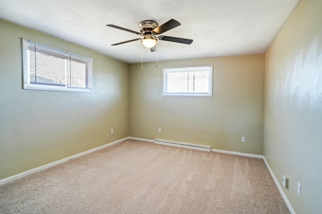 carpeted spare room with a baseboard radiator, baseboards, and ceiling fan