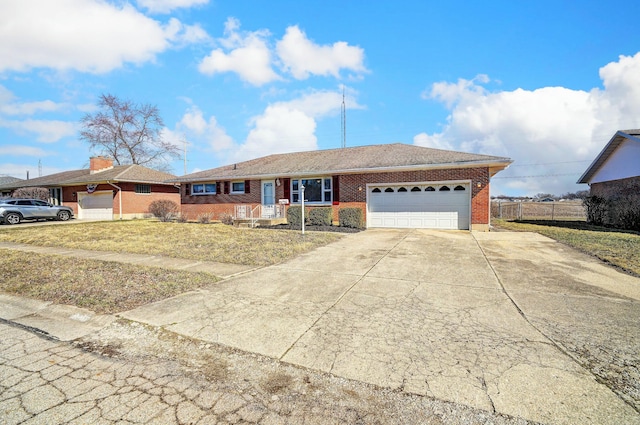 ranch-style house featuring brick siding, driveway, a garage, and fence