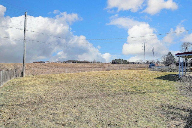 view of yard featuring a rural view and fence