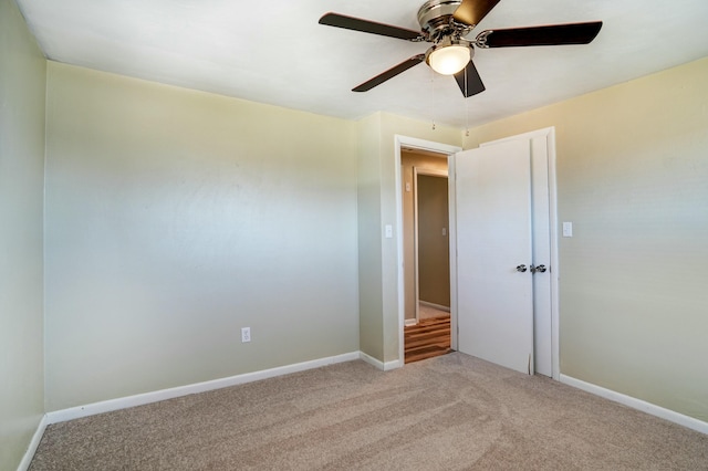 unfurnished bedroom featuring baseboards, ceiling fan, and carpet flooring