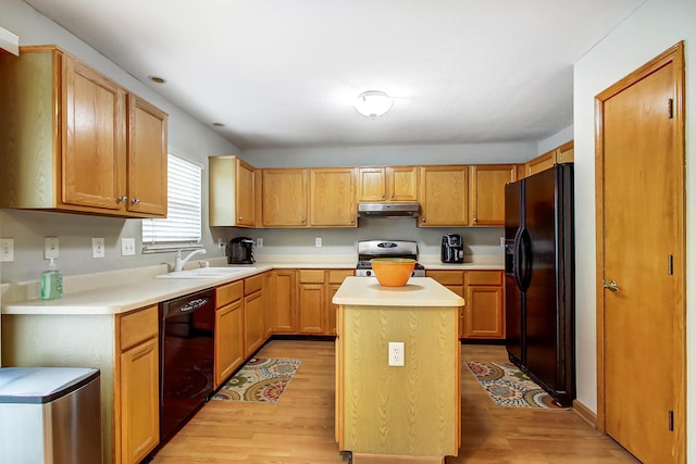 kitchen featuring sink, black appliances, light hardwood / wood-style floors, and a kitchen island