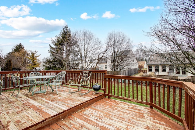 wooden deck featuring a lawn