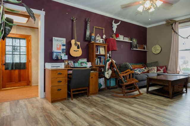 living area featuring stairs, a ceiling fan, wood finished floors, and ornamental molding