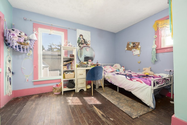 bedroom featuring lofted ceiling, a textured ceiling, and hardwood / wood-style flooring