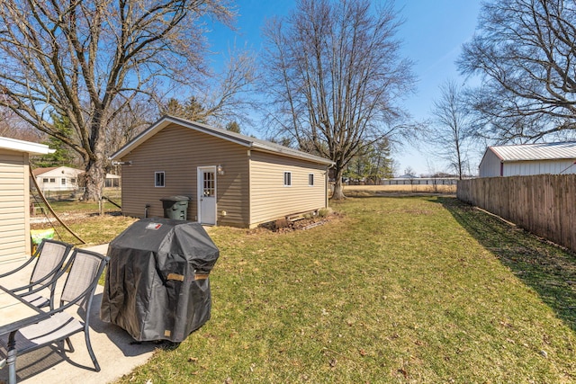 view of yard featuring an outdoor structure and fence