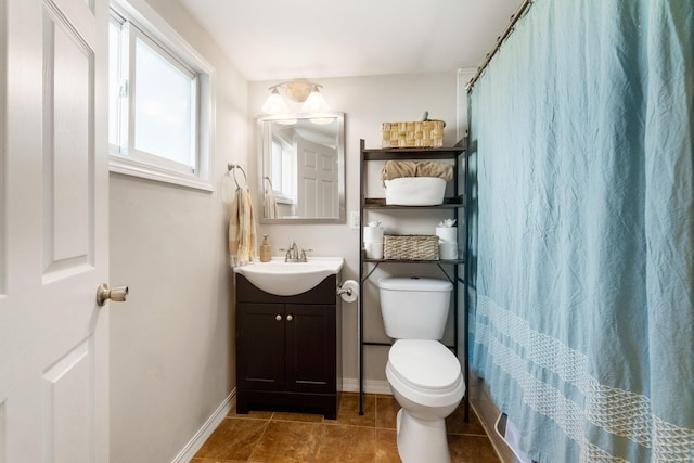 bathroom featuring toilet, curtained shower, tile patterned flooring, baseboards, and vanity