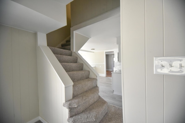 staircase with wood finished floors