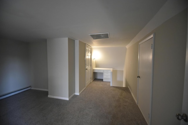 hallway featuring visible vents, carpet flooring, a baseboard heating unit, and baseboards