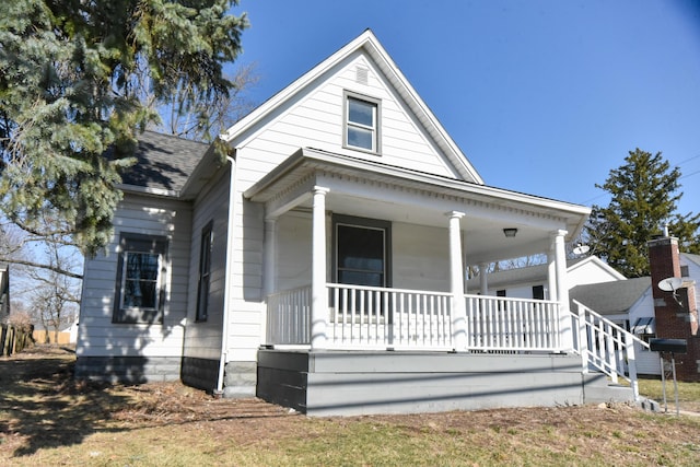 view of front of house featuring a porch and a shingled roof