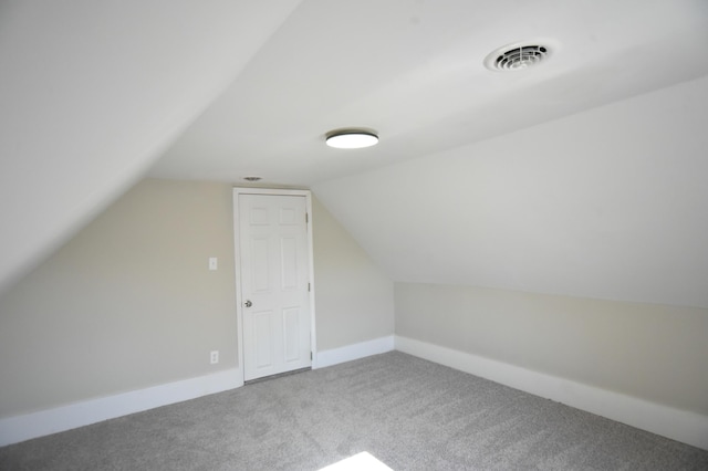 bonus room with visible vents, baseboards, carpet flooring, and vaulted ceiling