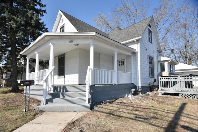 view of front of property with covered porch and a shingled roof