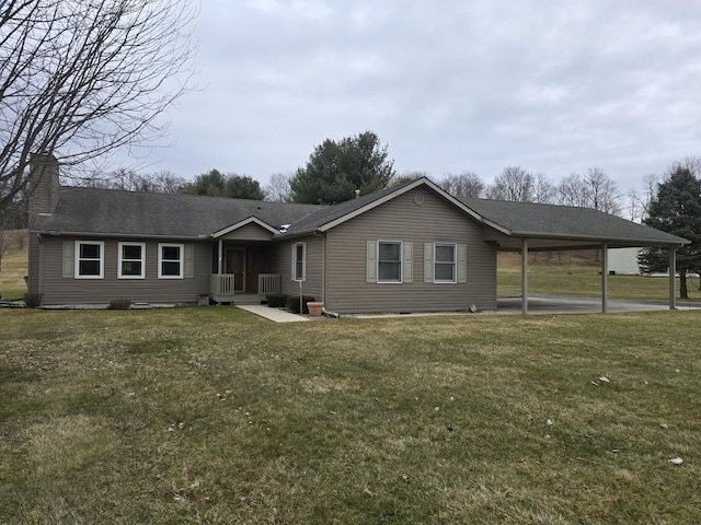 ranch-style house featuring a shingled roof, a carport, and a front yard